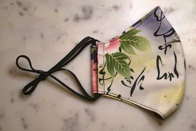 Reusable cotton face mask with a leaf print
